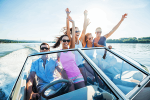 Cheerful group of young people enjoying in speedboat ride.