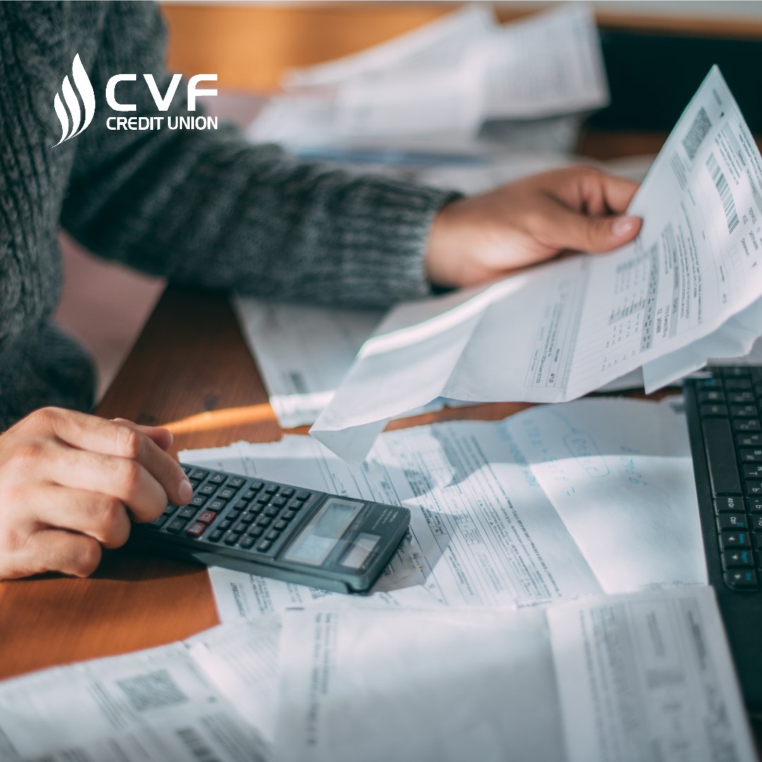 Close-up of male hands with a utility bill, a lot of checks and a calculator on the table. The man considers the costs of gas, electricity, heating.