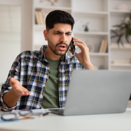 man on laptop and phone