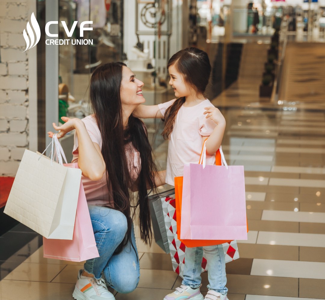 young mother and daughter holding shopping bags, shopping in the mall. Family shopping.