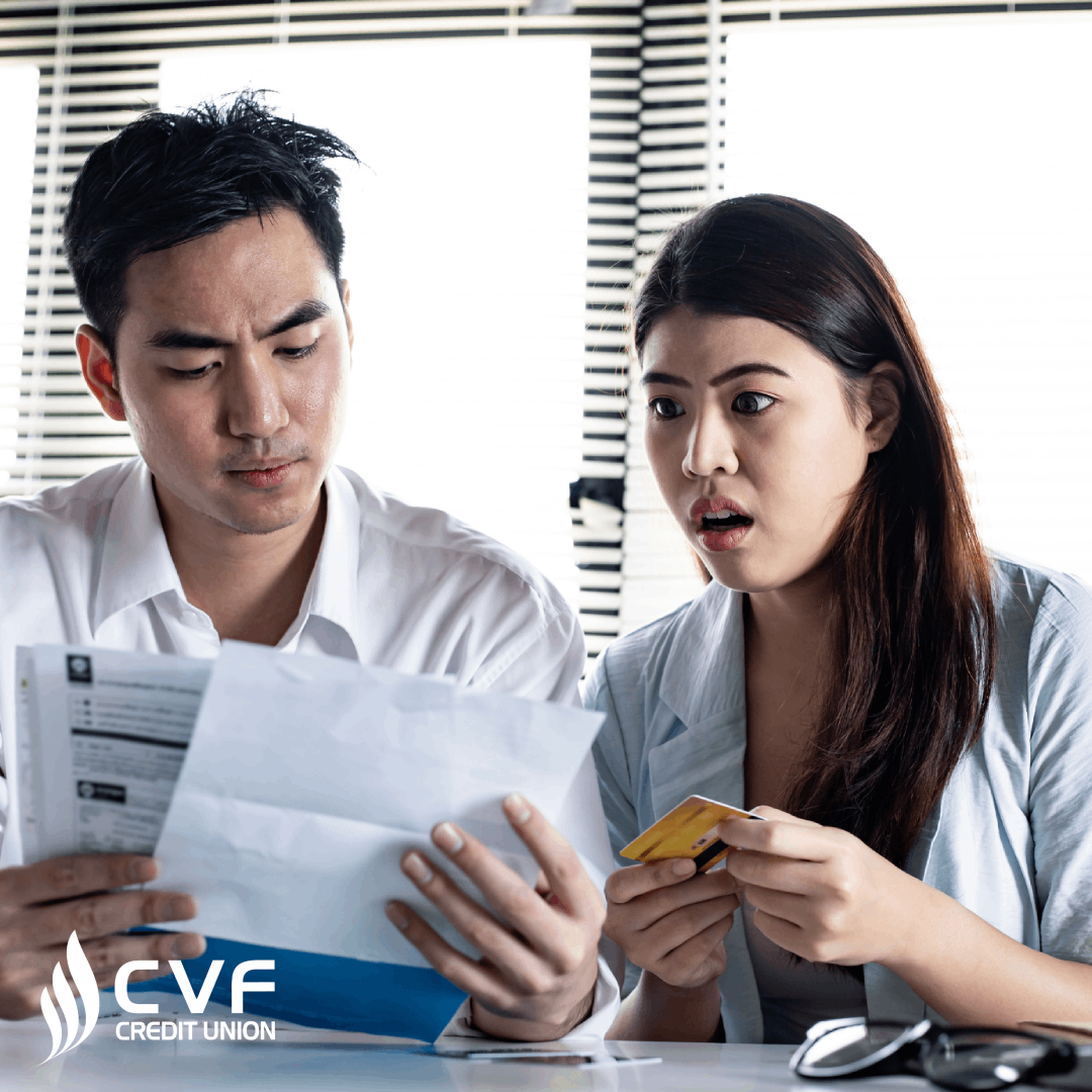 Couple looking at debit, bills